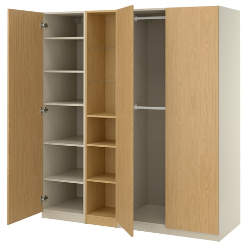 An open light wood-colored PAX wardrobe with shelves and hanging space. Its made of particleboard and has a modern minimalist design.