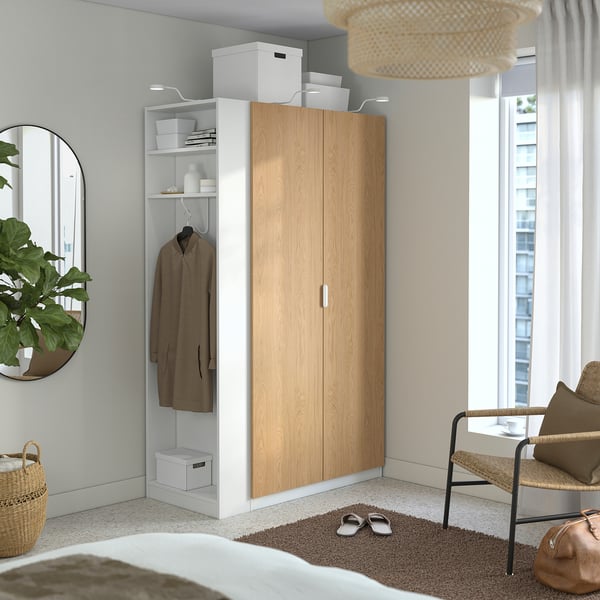 Modern oak-white wardrobe in neutral room with hanging space, shelves, and storage.