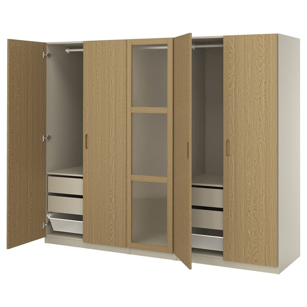 Wooden wardrobe PAX in oak color with metal handles, featuring two open sections.