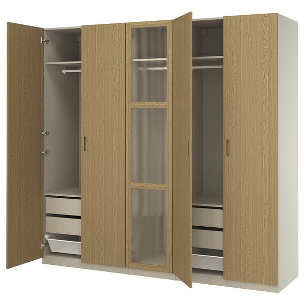 Displays an open wooden PAX wardrobe with hinges, showcasing drawers and shelves inside.