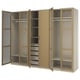 An open light oak PAX wardrobe. It has shelves, hanging rails, and pull-out trays for storage.