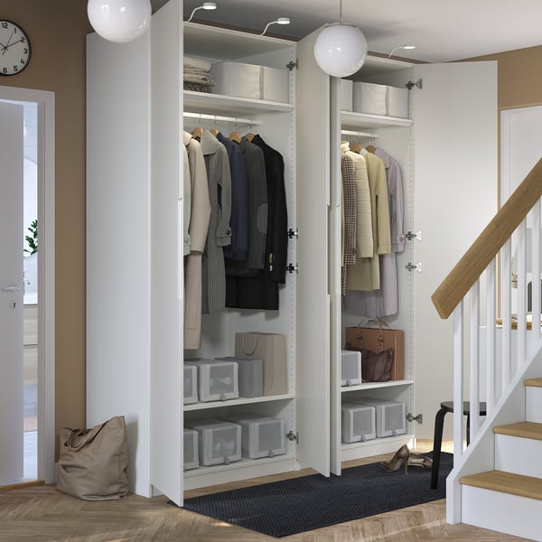 Open wardrobe with clothes, storage, and lights.