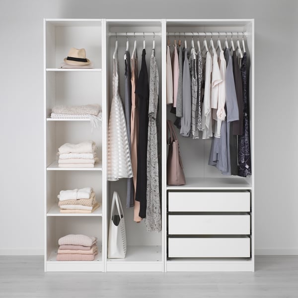 A white wardrobe with shelves, folded clothes, hanging garments, drawers, and storage boxes.