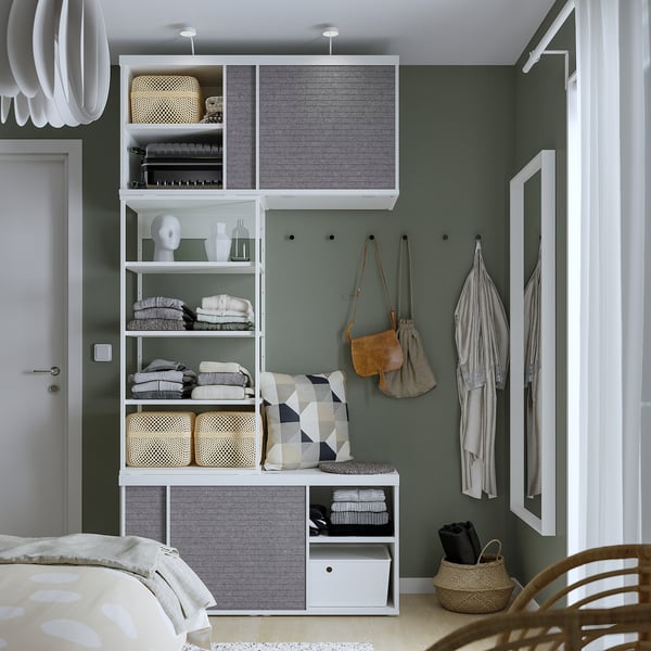 Modern bedroom with PLATSA wardrobe, featuring adjustable shelves, sliding doors, and hanging storage.