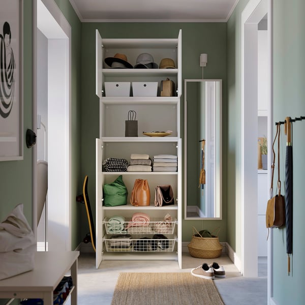 Modern closet with shelves holding bags, hats, and folded clothes, featuring adjustable feet and wall attachment.