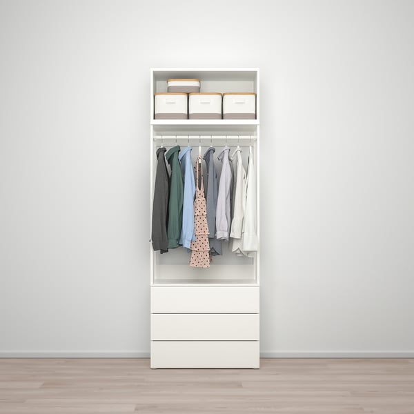 A white PLATSA wardrobe with shelves and drawers. Clothes hang neatly, showing organised storage.