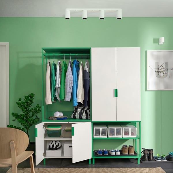Modern closet setup with green & white PLATSA units, offering versatile storage for clothes and shoes. Hanging rail, shelves, and baskets.