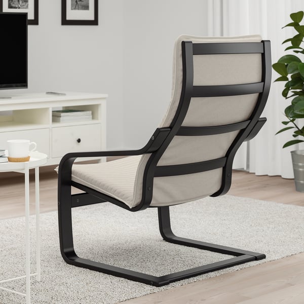 Comfortable POÄNG armchair with bentwood frame supporting neck, in living room setting.