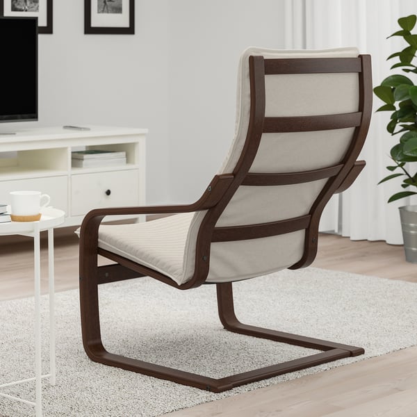 Modern armchair with curved back support, made of bentwood, sits on a light rug in a cosy living room with a wooden floor.