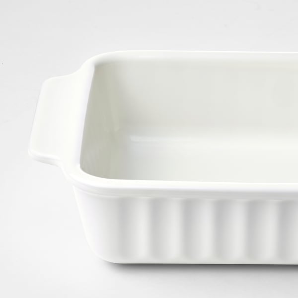 Empty white oblong baking dish with handles, clean and ready for use.