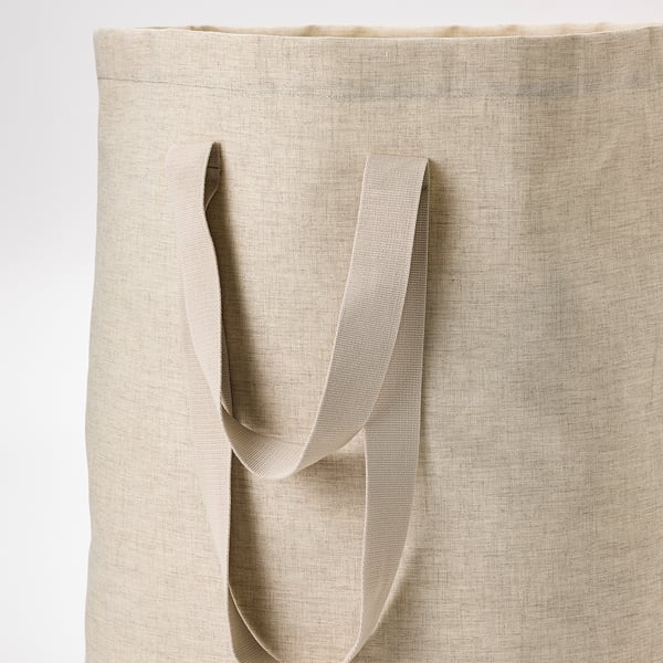 Large canvas laundry tote with sturdy handles, ideal for carrying clothes.