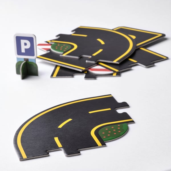 Vibrant toy car tracks with detailed markings and parking sign.