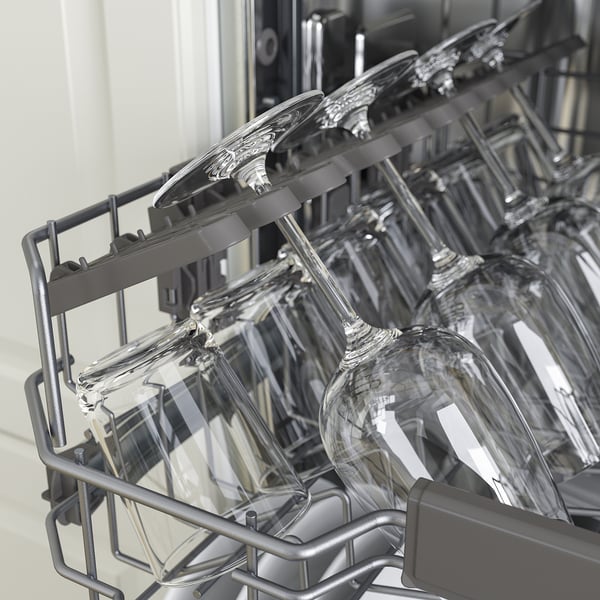 Dishwashers upper rack with stemmed glasses, showcasing its height-adjustable feature.