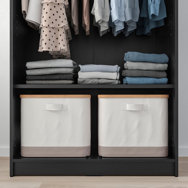 Organised closet with shelves and bins. Clothes hung and folded neatly. Safety fitting for stability.