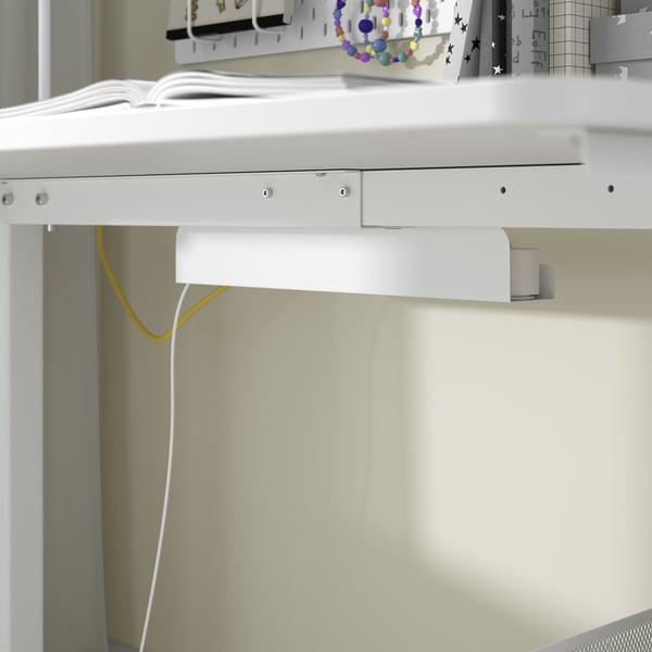 White under-desk cable management organiser with cord slots, part of RELATERA series.