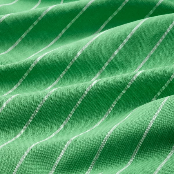 Close-up of green striped kitchen towel with white lines, soft-textured, made of recycled cotton.