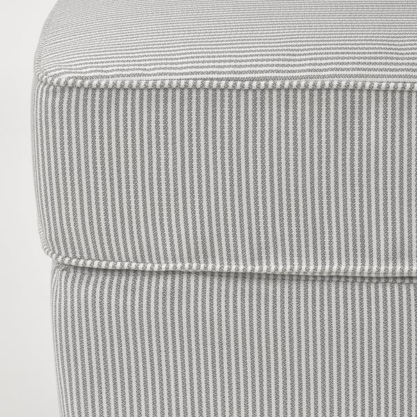 Close-up of striped, upholstered furniture with neat stitching and texture.
