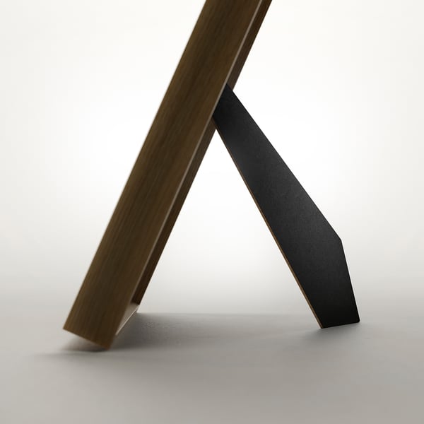 A minimalist picture frame shown from below, able to stand and hang, displaying modern design.