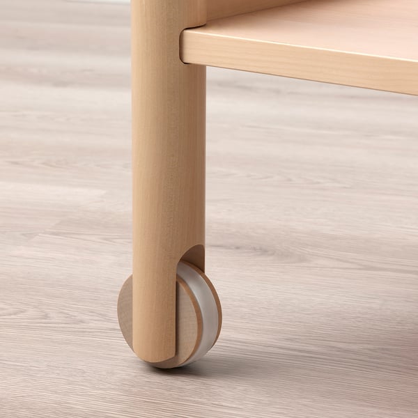 Close-up of RÖNNINGE trolleys birch leg with built-in castor, showing smooth finish and sturdy design.