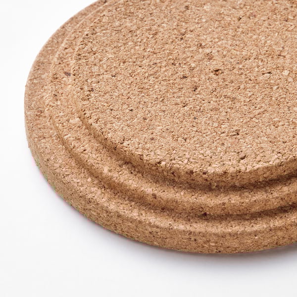 Stack of natural cork coasters, each with a smooth, circular edge.