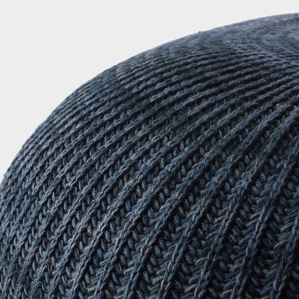 Close-up a dark knitted pouffes texture, showcasing intricate stitching and soft fabric.