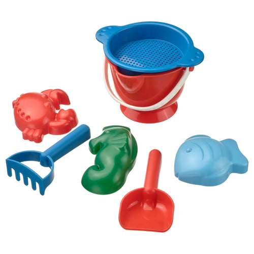 Bright beach toy set includes red crab, blue rake, green duck, blue fish, red shovel, and red/blue bucket with strainer. Fun for sand play.