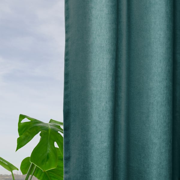 Teal curtains, room-darkening, hang near plant, darkening window, pleat detail visible.