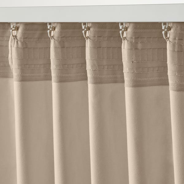 Curtains with hooks, light beige, pleated setup, filtered light function.