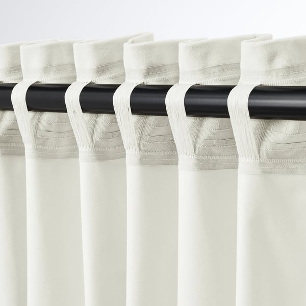 Close-up of SANELA curtains, showing pleated design and heading tape on black rod.