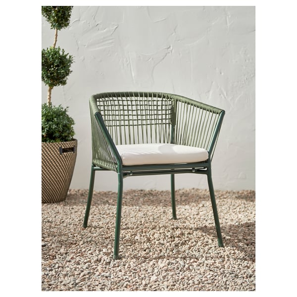 Modern green outdoor chair with woven seat and cushion.