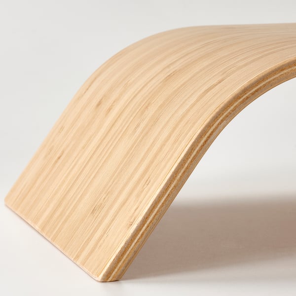 Sleek bamboo monitor stand, angled for ergonomic use, showcasing smooth craftsmanship.