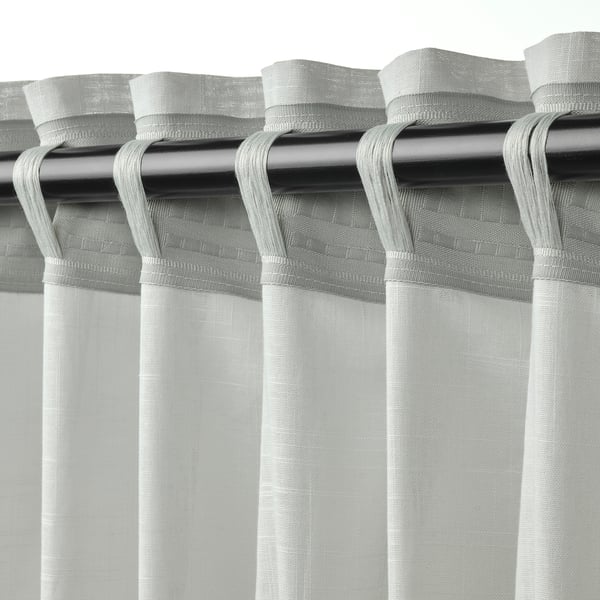 Grey SILVERLÖNN sheer curtains with textured pattern, headed tape, and weighted hems for light filtering and elegance.