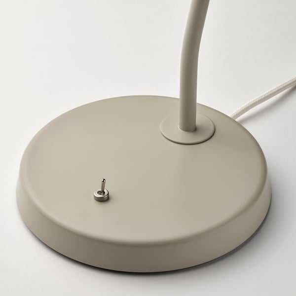 Modern desk lamp base with metallic finish, adjustable neck, and small power switch.
