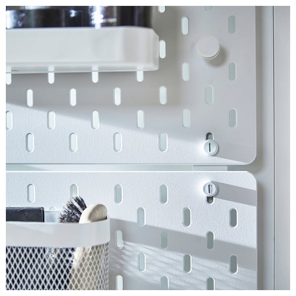White SKÅDIS pegboard connectors, attaching two panels, made of steel with powder coating.