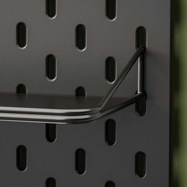 Metal shelf attached to pegboard with sturdy hooks. Modern design with smooth finish.