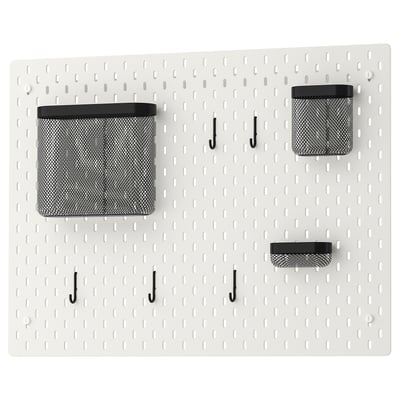 SKÅDIS white pegboard with black mesh bins and hooks for wall organization.