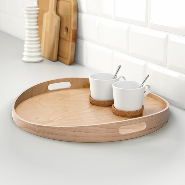 Wooden tray with handles holds two coffee cups and saucers.