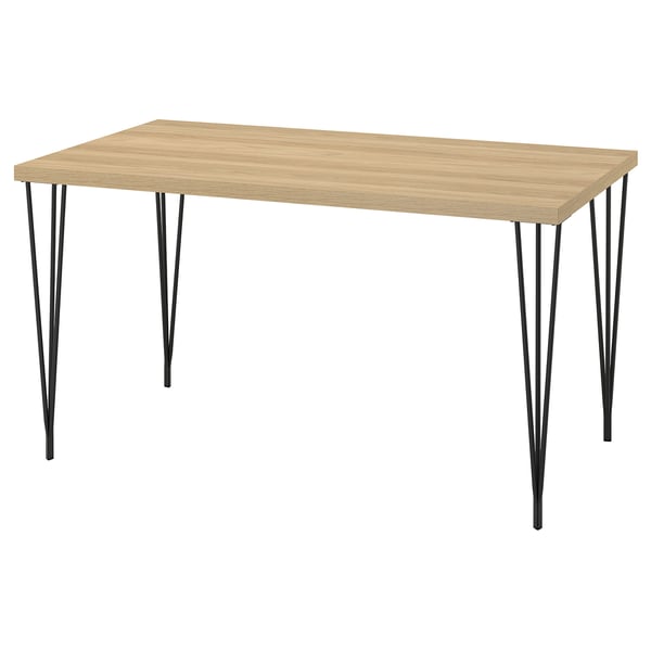 A SKÅLSTA table. Light wood top, black metal legs, rectangular shape with sleek design.