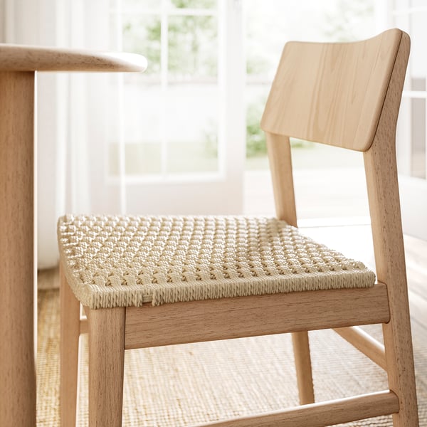 Modern light wooden chair with natural-finished seat and back, featuring scandinavian design for comfort and style.