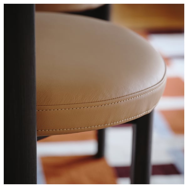 Close-up of a stylish, well-crafted leather stool with meticulous stitching, showcasing high-quality design.