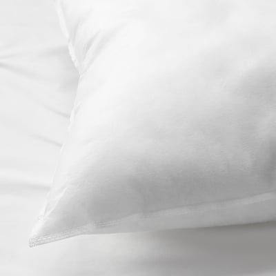 White pillow with smooth, crisp fabric. Plump with even stitching, suggesting high quality.