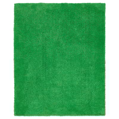 Bright green, rectangular, plush indoor/outdoor rug with a textured, grass-like surface.