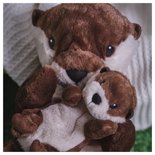 A plush otter family hugging; soft, embroidered eyes; recycled materials.