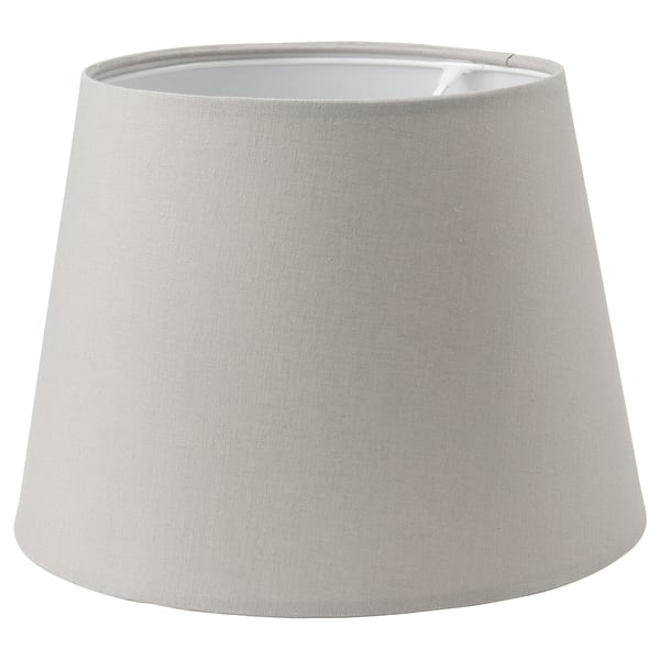A grey SKOTTORP lampshade, cylindrical in shape, made of eco-friendly fabric and plastic frame.