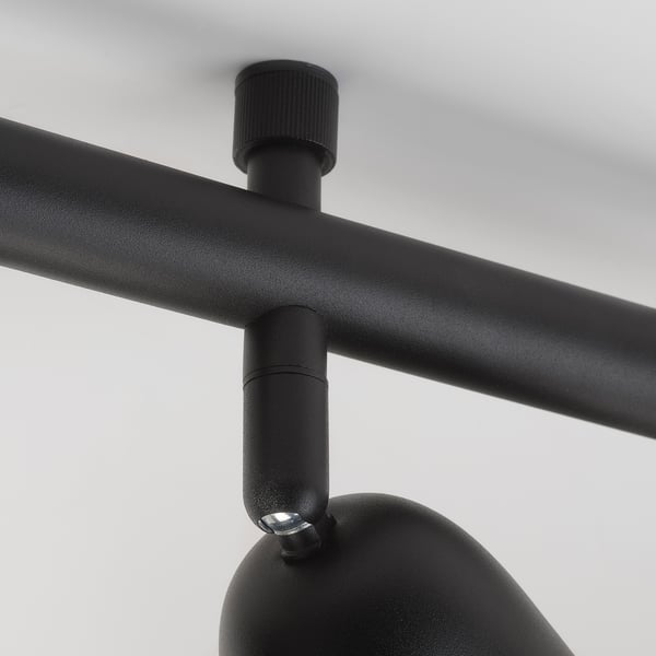 Black metal lamp joint; shows robust, adjustable design.