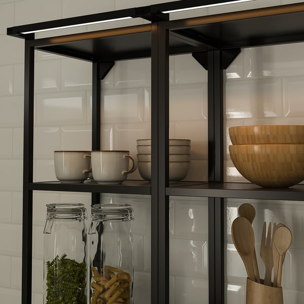 Modern kitchen shelf with built-in led lights, displaying bowls, cups, jars with ingredients, and wooden utensils.