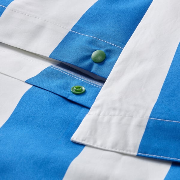 Blue and white striped duvet, close-up of press-stud button.