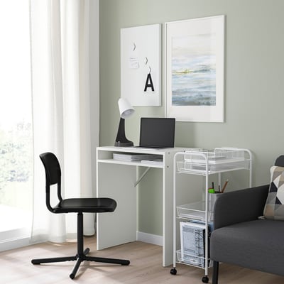 Minimalist home office with SMÄLLEN swivel chair, desk, laptop, lamp, grey sofa, mobile shelf, light green wall, abstract art.