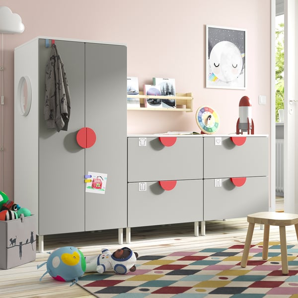 Childs room with grey SMÅSTAD furniture, red accents, & toys.