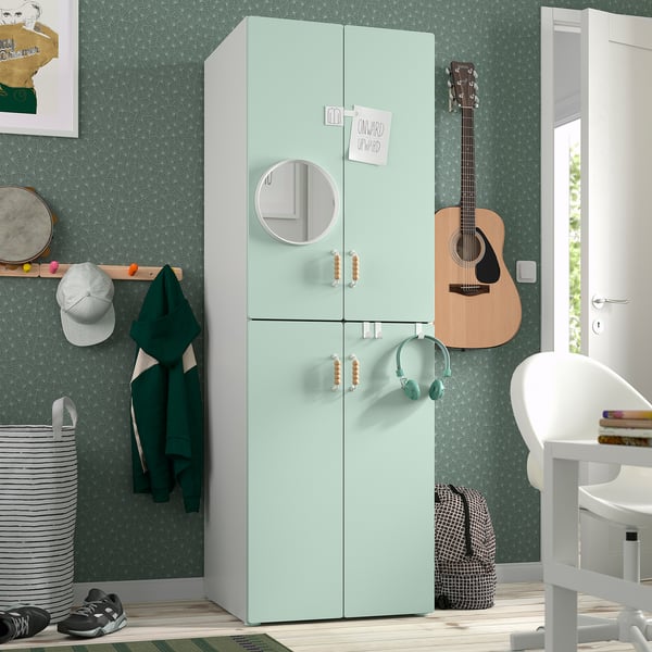 Green SMÅSTAD wardrobe with mirror, soft-close doors, guitar, chair.